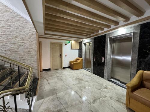 a hallway with a couch and a chair in a building at Alican 1 Hotel in Izmir