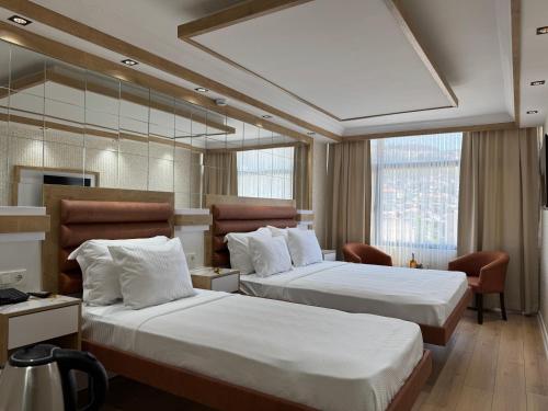 a hotel room with two beds and a window at Alican 1 Hotel in Izmir
