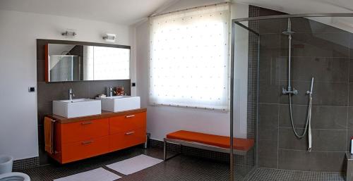 a bathroom with a shower and a sink and a mirror at Villa in Langa in Belvedere Langhe