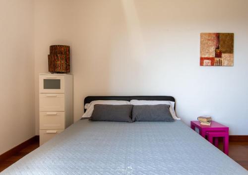 a bedroom with a bed and a purple night stand at Villa in Langa in Belvedere Langhe