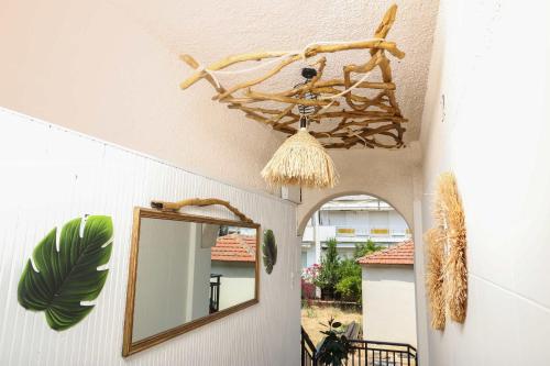 a mirror on the wall next to a room with a ceiling at Stratos Angels apartments in Pefkohori