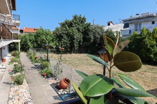 a garden with a fence and some plants at Stratos Angels apartments in Pefkohori