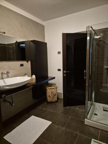 a bathroom with a sink and a shower and a tub at Villa in Langa in Belvedere Langhe