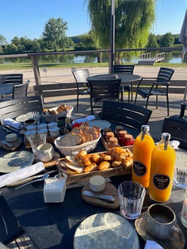 a table with food and bottles of orange juice at L'ile chaumette in Épervans