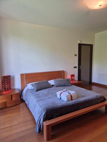 a bedroom with a large bed with a wooden frame at Villa in Langa in Belvedere Langhe
