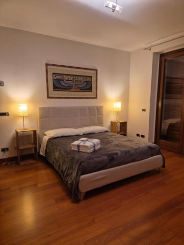 a bedroom with a large bed with two lamps at Villa in Langa in Belvedere Langhe