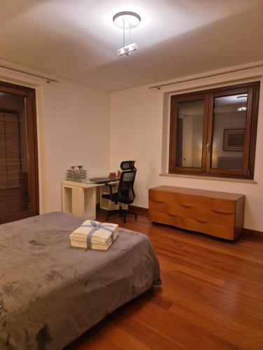 a bedroom with a bed and a desk and a chair at Villa in Langa in Belvedere Langhe