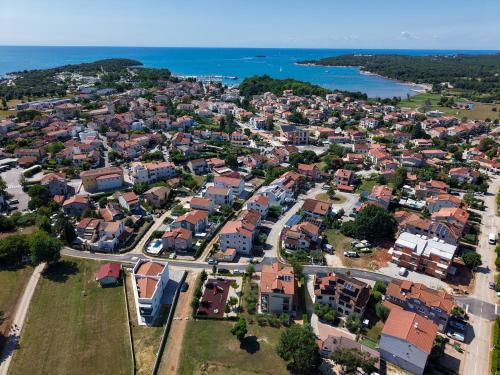 an aerial view of a city with houses and the ocean at Apartments Hana in Funtana in Funtana