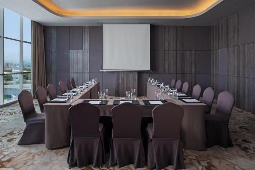 a conference room with a long table and chairs at Melia Makassar in Makassar