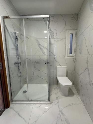 a bathroom with a shower and a toilet at Serenity Escape 2 Bed with Patio in Taʼ Penza