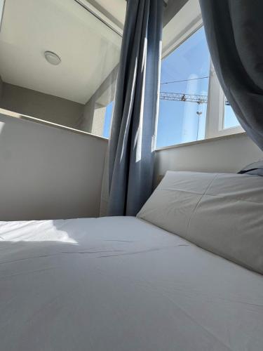 a bed in a room with a window at Serenity Escape 2 Bed with Patio in Taʼ Penza