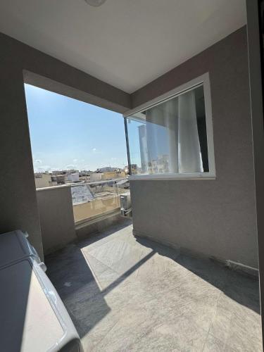 a room with a window with a view of the city at Serenity Escape 2 Bed with Patio in Taʼ Penza