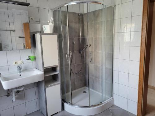 a bathroom with a shower and a sink at Ferienwohnung bei Helga in Tittmoning