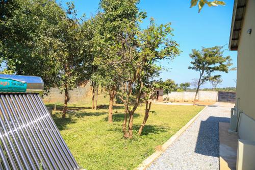 a view of a yard with trees and a fence at Forest Views Haven in Solwezi