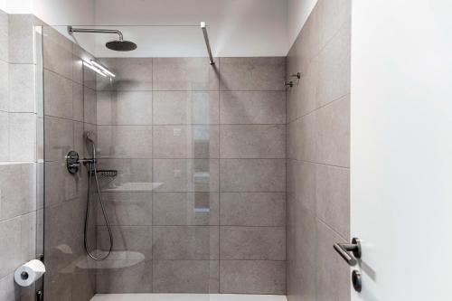 a bathroom with a shower with a glass door at Residenza Ticino by Quokka 360 - Modern Oasis near Bellinzona in Bellinzona