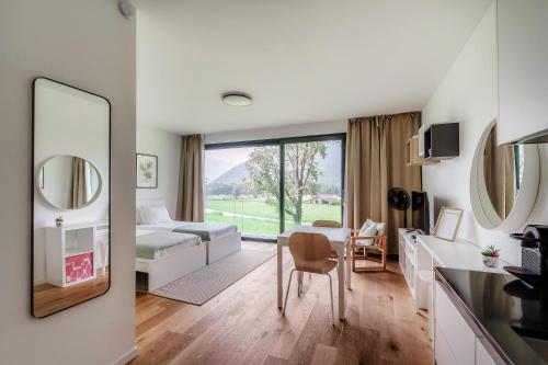 a room with a bed and a table with a mirror at Residenza Ticino by Quokka 360 - Modern Oasis near Bellinzona in Bellinzona