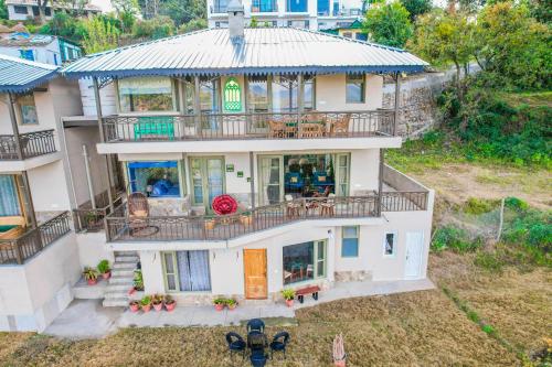 an aerial view of a house with a balcony at SaffronStays Edelweiss Estate Amore in Chaubattia