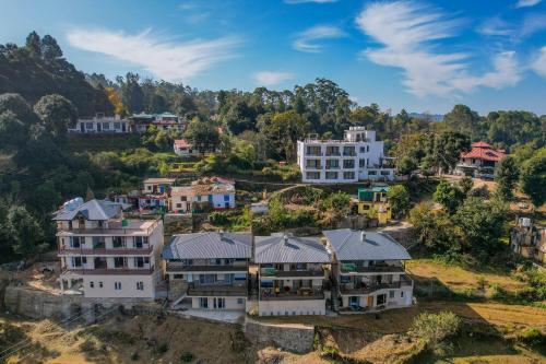 an aerial view of houses on a hill at SaffronStays Edelweiss Estate Amore in Chaubattia