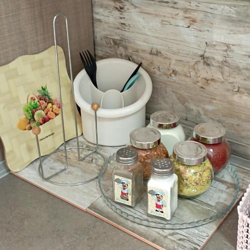 a glass tray with jars and a bucket of food at Apartman Icić in Pirot