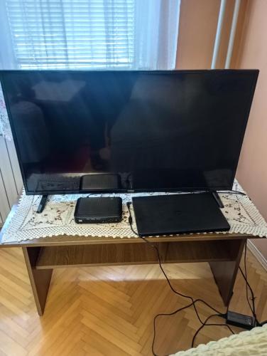 a large computer monitor sitting on a desk at Apartman Icić in Pirot