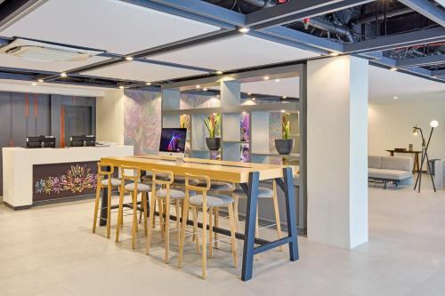 a dining room with a table and stools at Go Hotels Plus Bacolod - Newly Renovated in Bacolod