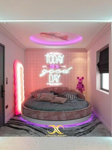 a room with a round bed with a neon sign at X-Digital HOTEL in Bắc Ninh