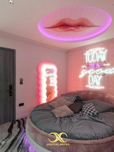 a bedroom with a round bed with a neon sign at X-Digital HOTEL in Bắc Ninh