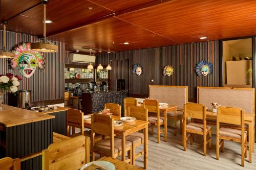 a dining room with wooden tables and chairs at Go Hotels Plus Bacolod - Newly Renovated in Bacolod