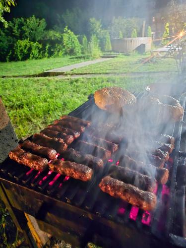 a group of sausages and other meats on a grill at Vila Nera in Železnička Stanica Karlovački Vinogradi