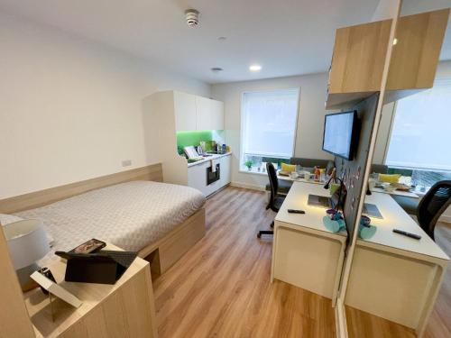 a bedroom with a bed and a desk with a computer at Riverside House at Guildford in Guildford