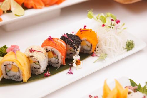 a plate of sushi on a white plate at Holiday Inn Bangkok by IHG in Bangkok