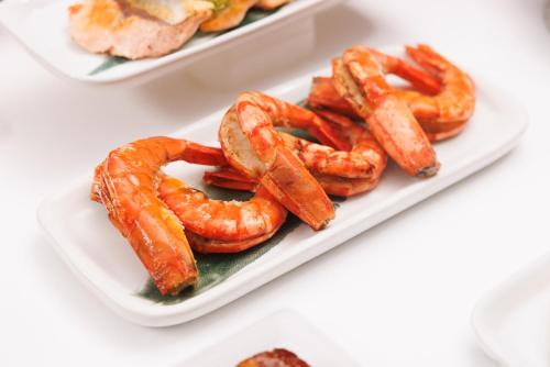 a plate of shrimp on a white plate at Holiday Inn Bangkok by IHG in Bangkok
