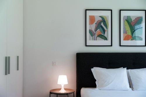 a bedroom with a bed with three pictures on the wall at Residenza Ticino by Quokka 360 - Modern Oasis near Bellinzona in Bellinzona