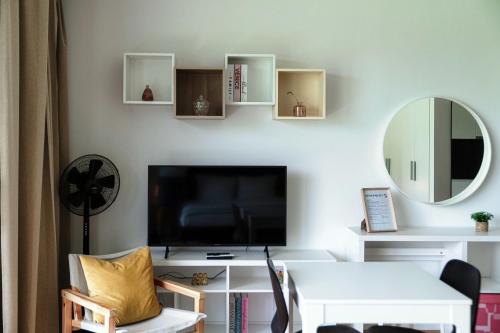 a living room with a tv and a mirror at Residenza Ticino by Quokka 360 - Modern Oasis near Bellinzona in Bellinzona