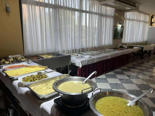 a buffet line of tables with different types of food at Hotel Kupola in Spille