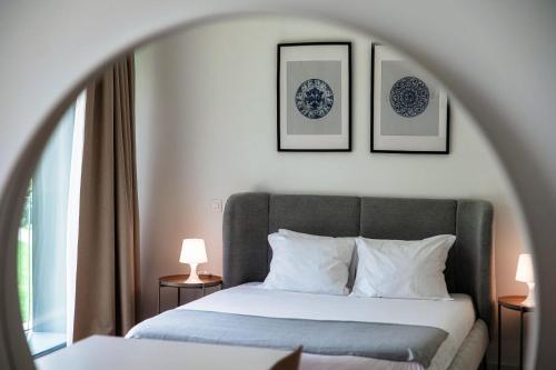 a bedroom with a bed and two pictures on the wall at Residenza Ticino by Quokka 360 - Modern Oasis near Bellinzona in Bellinzona
