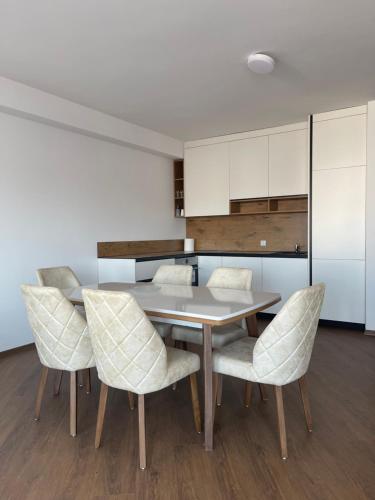 a dining room with a table and chairs at Skyline Apartment in Pristina