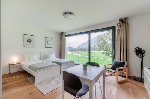 a bedroom with a bed and a large window at Residenza Ticino by Quokka 360 - Modern Oasis near Bellinzona in Bellinzona