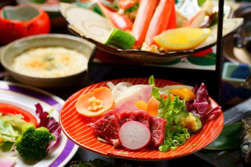 a plate of food with fruits and vegetables and dip at Hozantei in Minamioguni