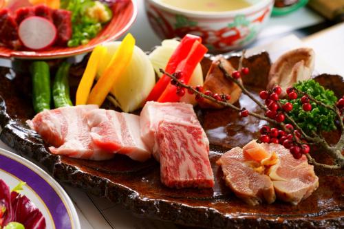 a plate of food with meat and vegetables on a table at Hozantei in Minamioguni