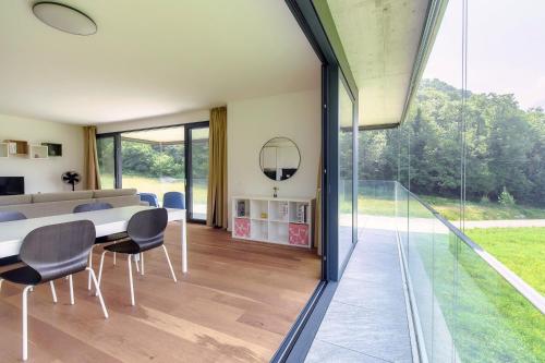 a dining room with a table and chairs at Residenza Ticino by Quokka 360 - Modern Oasis near Bellinzona in Bellinzona