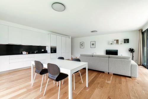 a living room with a table and chairs and a couch at Residenza Ticino by Quokka 360 - Modern Oasis near Bellinzona in Bellinzona