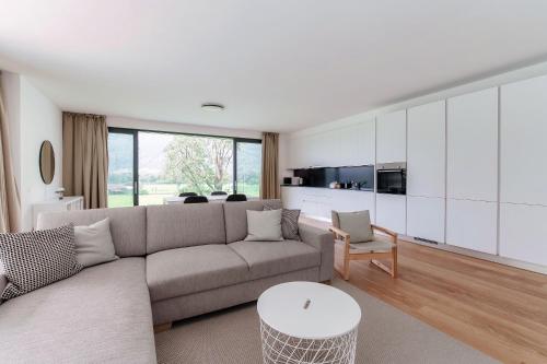 a living room with a couch and a table at Residenza Ticino by Quokka 360 - Modern Oasis near Bellinzona in Bellinzona