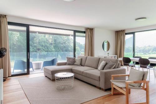 a living room with a couch and a table at Residenza Ticino by Quokka 360 - Modern Oasis near Bellinzona in Bellinzona