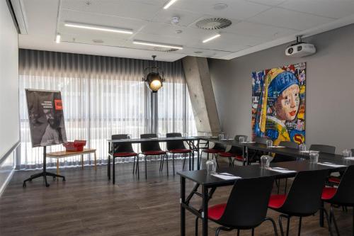 a dining room with black tables and black chairs at Radisson RED Hotel V&A Waterfront Cape Town in Cape Town