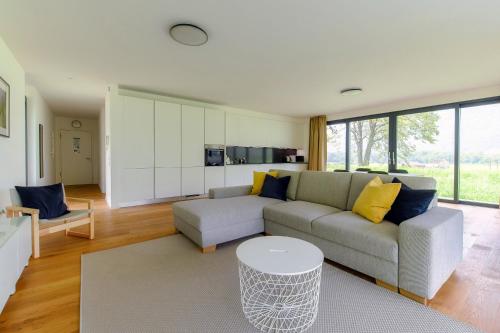a living room with a couch and a table at Residenza Ticino by Quokka 360 - Modern Oasis near Bellinzona in Bellinzona