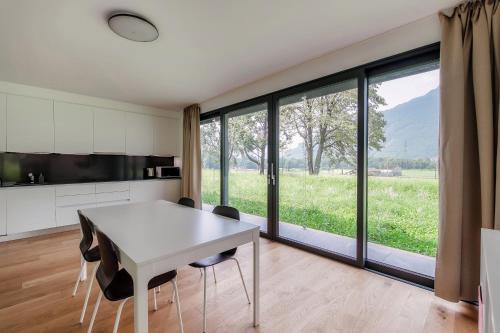 a kitchen and dining room with a table and chairs at Residenza Ticino by Quokka 360 - Modern Oasis near Bellinzona in Bellinzona