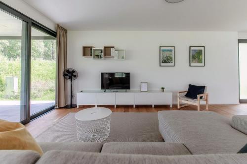 a living room with a couch and a tv at Residenza Ticino by Quokka 360 - Modern Oasis near Bellinzona in Bellinzona