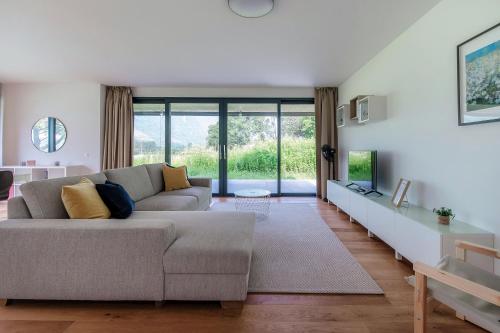 a living room with a couch and a large window at Residenza Ticino by Quokka 360 - Modern Oasis near Bellinzona in Bellinzona