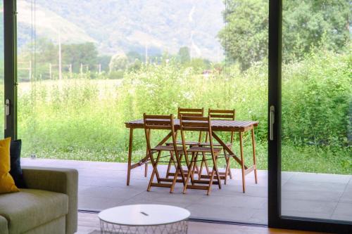 a patio with a table and chairs and a couch at Residenza Ticino by Quokka 360 - Modern Oasis near Bellinzona in Bellinzona